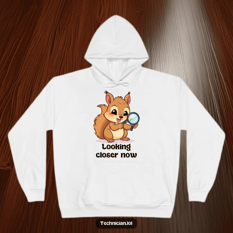 Funny Hoodies: A gleeful squirrel uses a magnifying glass to examine circuits, embodying focused thought and quirky technical interest for cozy wear.